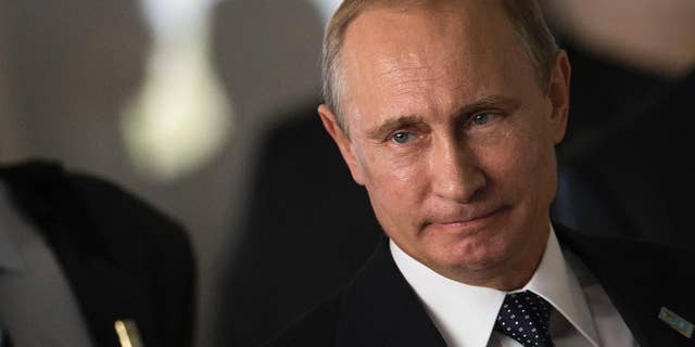 FILE - This, July 16, 2014, file photo shows Russia's President Vladimir Putin as he arrives for an official group photo during the BRICS summit at the Itamaraty palace, in Brasilia, Brazil. Months after Russia annexed Crimea and stepped up support for separatists in eastern Ukraine, Europe and the U.S. are still searching for an effective way to persuade Putin to change course. (AP Photo/Felipe Dana, File )