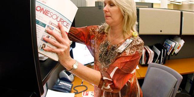 Jennie Taylor, a marking coordinator at LifeWay Christian Resources, works in her office on Wednesday, Oct. 6, 2010, in Nashville, Tenn. Lifeway has a partnership with backgrounchecks.com to offer background screenings to Lifeway customers at discounted prices. Taylor said that many churches are now doing background checks on employees. "If they're not doing it, they're considering it and looking for options and sources to do it," Taylor said.