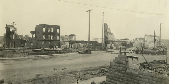 In this June 1, 1921, photo provided by the Tulsa Historical Society are businesses that were burned and looted in Tulsa's Greenwood District during race riots that left 300 blacks dead and hundreds more wounded in a span of 18 hours. Wyatt Tate Brady, who arrived in Tulsa in 1890, had become a man of means and influence by the time the territory became Oklahoma in 1907.