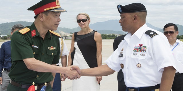 U.S. Army Lt. Col. Romel Pajimula, Defense POW/MIA Accounting Agency (DPAA) detachment commander, right, greets Senior Col. Nguyen Huu Luong, Vietnamese Office for Seeking Missing Persons (VNOSMP) Ministry of Defense deputy director, prior to witnessing a repatriation ceremony, Da Nang, Socialist Republic of Vietnam, July 8, 2018.