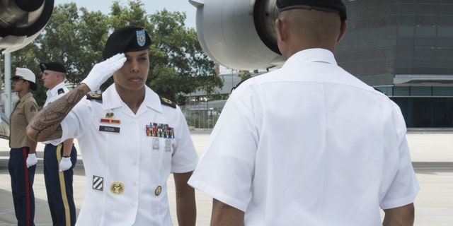 U.S. Army Sgt. 1st Class Jacklyn Sosa, Defense POW/MIA Accounting Agency (DPAA) team sergeant, renders a salute to Lt. Col. Romel Pajimula, DPAA detachment commander, prior to commencing a repatriation ceremony.