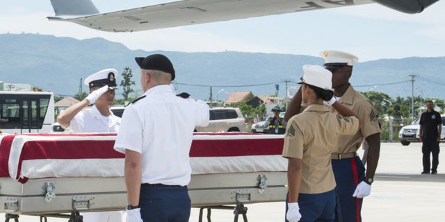 U.S. service members, assigned to DPAA, render salute during a repatriation ceremony.