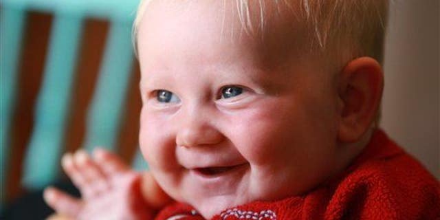 This May 7, 2011 photo shows a 4-month-old baby smiling in Toronto.