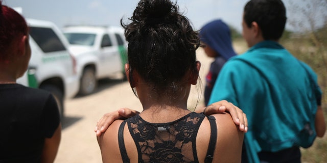 MISSION, TX - JULY 24: Unaccompanied minors from El Salvador await transport to a U.S. Border Patrol processing center after they crossed the Rio Grande from Mexico into the United States on July 24, 2014 in Mission, Texas. Tens of thousands of undocumented immigrants, many of them unaccompanied minors, have crossed illegally into the United States this year and presented themselves to federal agents, causing a humanitarian crisis on the U.S.-Mexico border. (Photo by John Moore/Getty Images)