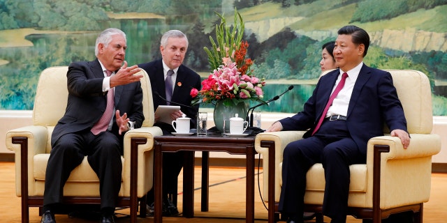 U.S. Secretary of State Rex Tillerson, left, chats with China's President Xi Jinping during a meeting at the Great Hall of the People in Beijing, Saturday, Sept. 30, 2017.