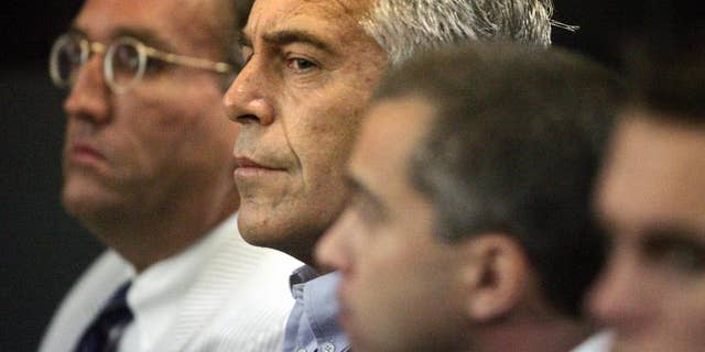 This July 30, 2008 photo shows Jeffrey Epstein in custody in West Palm Beach, Fla. Epstein was suspected nearly a decade ago of paying for sex with underage girls. The FBI abruptly dropped its investigation a few years ago, and Epstein pleaded guilty to a single state charge of soliciting prostitution. He served 13 months in jail. Now, two women who say they were sexually abused as girls by Epstein are hoping a trove of new documents will get the case reopened. (AP Photo/Palm Beach Post, Uma Sanghvi)