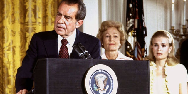 In this file photo, U.S. President Richard Nixon, listened to by First lady Pat Nixon and daughter Tricia Nixon (R), says goodbye to family and staff in the White House East Room on August 9, 1974.