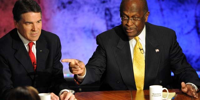 Republican presidential candidates Texas Gov. Rick Perry and businessman Herman Cain participate in a presidential debate at Dartmouth College in Hanover, N.H., Tuesday, Oct. 11, 2011.