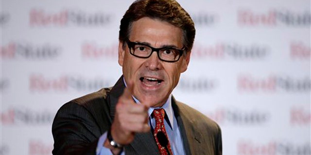 FILE - This Aug. 8, 2014, file photo shows Governor Rick Perry as he speaks at the 2014 Red State Gathering, in Fort Worth, Texas. Perry has been indicted for abuse of power after carrying out a threat to veto funding for state public corruption prosecutors. The Republican governor is accused of abusing his official powers by publicly promising to veto $7.5 million for the state public integrity unit at the Travis County District Attorney's office. He was indicted by an Austin grand jury Friday, Aug. 15. (AP Photo/Tony Gutierrez)