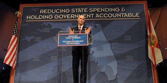 FILE: Florida Gov. Rick Scott announces his new budget during a Tea Party event in Eustis, Fla., on Feb. 7.