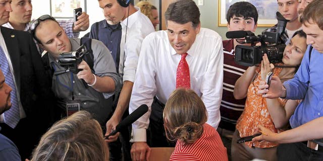 Republican presidential candidate, Texas Gov. Rick Perry talks with locals in a cafe during a visit to downtown Portsmouth, N.H., Thursday, Aug. 18, 2011. (AP Photo/Cheryl Senter)