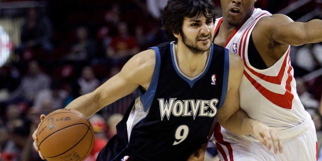 Minnesota Timberwolves' Ricky Rubio drives toward the basket as Houston Rockets' Kyle Lowry, right, defends during the first quarter of an NBA basketball game on Friday in Houston. (AP Photo/David J. Phillip)