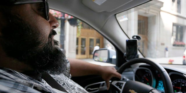 In this July 19, 2016 photo, Carlos Correa drives in Chicago. Correa is currently in Lyft's;s Express Drive rental program, a partnership with GM which allows a weekly rental, available for up to eight weeks. (AP Photo/Tae-Gyun Kim)