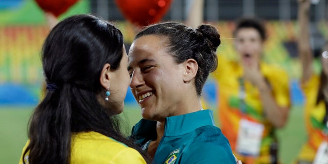 Brazil's Isadora Cerullo, right, shares a moment with her partner Marjorie Enya, after she was asked her to marry her, after the medal ceremony for the women's rugby sevens match at the Summer Olympics in Rio de Janeiro, Brazil, Monday, Aug. 8, 2016. (AP Photo/Themba Hadebe)