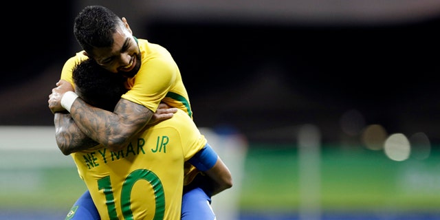 Brazil's Gabriel Barbosa celebrates with teammate Neymar after scoring his team's first goal during a group A match of the men' s Olympic football tournament between Brazil and Denmark in Salvador, Brazil, Wednesday Aug. 10, 2016.(AP Photo/Leo Correa)