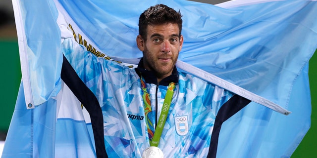 Silver medalist Juan Martin del Potro, of Argentina, drapes a flag over his shoulders as he thanks the crowd after the men's singles gold medal match at the 2016 Summer Olympics in Rio de Janeiro, Brazil, Sunday, Aug. 14, 2016. (AP Photo/Charles Krupa)