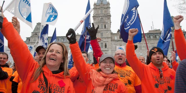 May 3, 2012: Union worker Melanie Tremblay, center, holds a petition of Rio Tinto Alcan locked out workers to be tabled at the legislature on Thursday, in Quebec City.