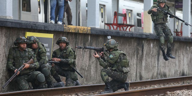 Brazilian soldiers conduct a counterterrorism drill simulating an attack at the Deodoro train station on July 16, 2016 in Rio de Janeiro, Brazil. Brazil announced yesterday it was bolstering security for the Rio 2016 Olympic Games following the truck attack in Nice, France, which killed at least 84 people. Deodoro is one of four main venue locations for the upcoming Olympics which begin August 5. (Photo by Mario Tama/Getty Images)