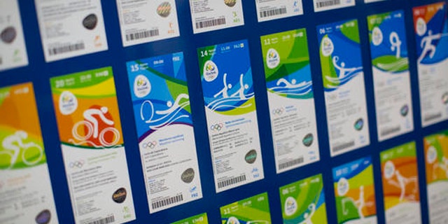 FILE - This May 20, 2016 file photo shows the presentation of the new design of Olympic tickets at Rio Olympic headquarters in Rio de Janeiro, Brazil. Olympic organizers say they want to return about $3 million in ticket refunds to people who returned their tickets. They say they have the money, but are having trouble paying people back due to missing bank details, etc. According to organizers, about 90 percent of refunds have already been made. (AP Photo/Felipe Dana, File)