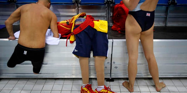 FILE - In this Aug. 31, 2012 file photo, Spain's Xabi Torres jumps next to his prosthesis as he leaves the swimming pool after training ahead of the competition at the 2012 Paralympics Olympics in London. The countdown clock for the Paralympic Games in Rio reaches 100 days on Monday with about 4,300 athletes participating, far fewer than the 10,500 in the Olympics. The Paralympic Games open Sept. 7.(AP Photo/Emilio Morenatti, File)
