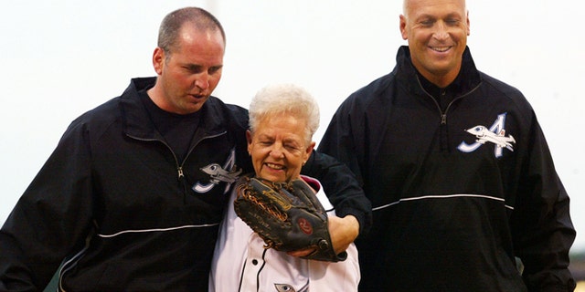 June 2002: Cal Ripken Jr., right, owner of the Aberdeen IronBirds, and his brother, Bill, walking off the field with their mother after she threw out the first pitch.