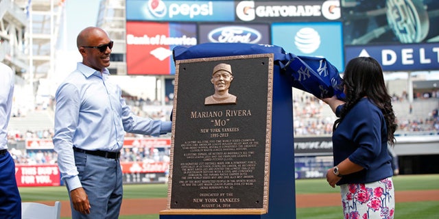Former New York Yankees closer Mariano Rivera, left, and his wife, Clara, unveil his Monument Park plaque before a baseball game Sunday, Aug. 14, 2016, at Yankee Stadium in New York. (AP Photo/Rich Schultz/Pool)