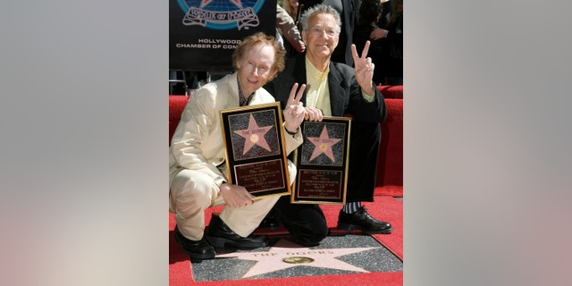 The Doors' guitarist Robby Kreiger, left, and keyboardist Ray Manzarek pose for photographers during the dedication of the 2,329th Star on the Hollywood Walk of Fame in Hollywood February 28, 2007