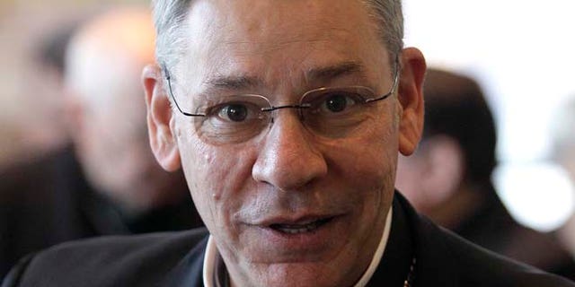 In this Nov. 14, 2011 file photo, Bishop Robert Finn, of Kansas City, Mo., leaves a meeting at the United States Conference of Catholic Bishops' annual fall assembly in Baltimore.