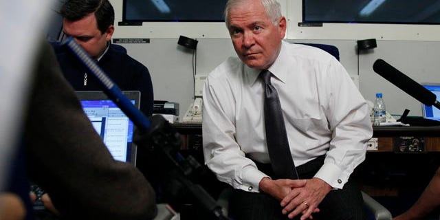 June 3: Defense Secretary Robert Gates pauses to listen to media questions aboard a U.S. Military aircraft en route to Singapore. (AP)