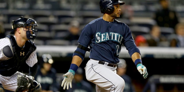 NEW YORK, NY - APRIL 29: Robinson Cano #22 of the Seattle Mariners takes a swing in the seventh inning as Brian McCann #34 of the New York Yankees defends on April 29, 2014 at Yankee Stadium in the Bronx borough of New York City. (Photo by Elsa/Getty Images)