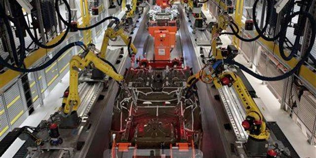 In this file photo, robots build automobiles on an assembly. It's not clear what type of machine was involved in the fatal accident.