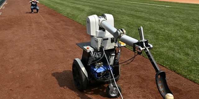 Jamie Gewirtz waits for a robot to throw him a ball at Citizens Bank Park in Philadelphia, Monday April 18, 2011.