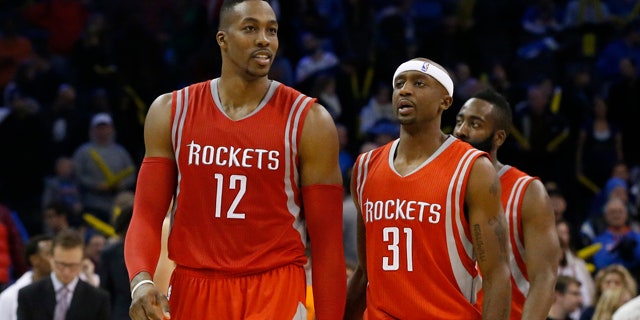 November 16, 2014: Houston Rockets' Dwight Howard (12), smiles as he, Jason Terry (31) and James Harden, right, walk off the court during a time out in the fourth quarter of an NBA basketball game in Oklahoma City. Houston won 69-65. (AP Photo/Sue Ogrocki)