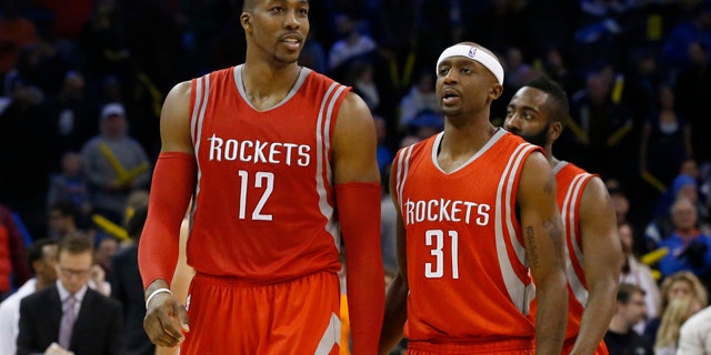 November 16, 2014: Houston Rockets' Dwight Howard (12), smiles as he, Jason Terry (31) and James Harden, right, walk off the court during a time out in the fourth quarter of an NBA basketball game in Oklahoma City. Houston won 69-65. (AP Photo/Sue Ogrocki)