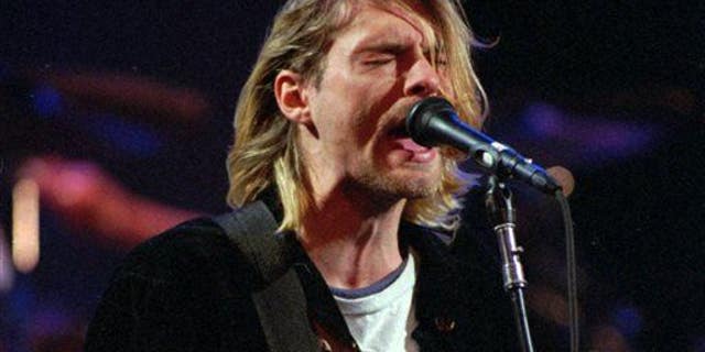This Dec. 13, 1993 file photo shows Kurt Cobain of the Seattle band Nirvana performing in Seattle, Wash.