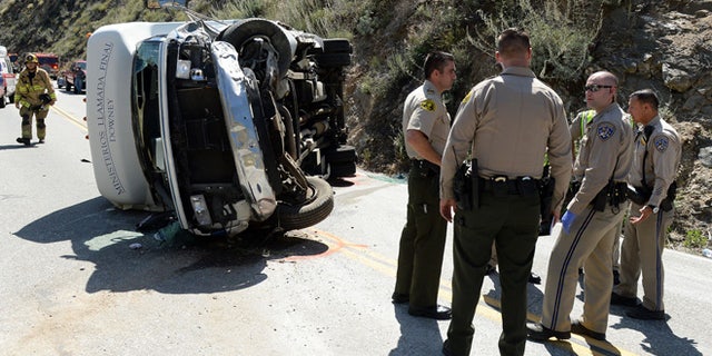 People were injured after a small tour bus crashed and rolled over on highway 330 approximately 2 miles north of the 210 freeway Sunday, May 22, 2016. Both directions of the 330 are currently closed. Cause of the crash is under investigation. (Will Lester /The Inland Valley Daily Bulletin via AP) MANDATORY CREDIT