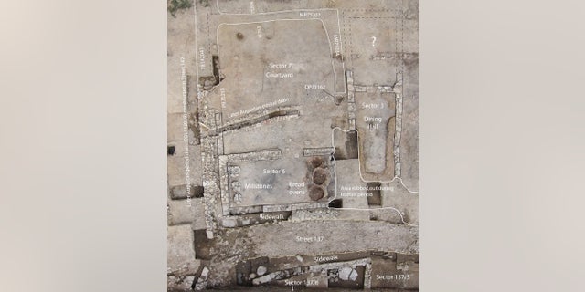 An aerial view of the excavated tavern. Note the kitchen, which held the bread ovens and millstones, and the dining hall, which has a bench around three of its walls.