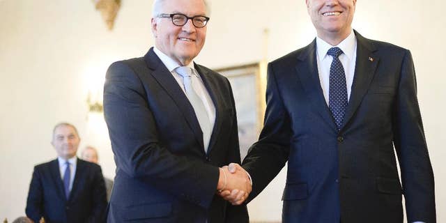 German Foreign Minister Frank-Walter Steinmeier, left, shakes hands with Romanian President Klaus Werner Iohannis, right, at the Cotroceni Presidential Palace in Bucharest, Romania, Monday, Mar. 9, 2015. (AP Photo/Octav Ganea, Mediafax) ROMANIA OUT