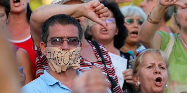 Aug. 21, 2012: Protesters shout anti presidential slogans downtown Bucharest, Romania.