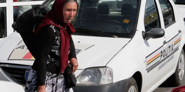 A Romanian Roma woman carries a bag after arriving from France in Bucharest, Romania, Thursday, Aug. 19, 2010. France expelled nearly 100 Gypsies, or Roma, to their native Romania on Thursday as part of a very public effort by conservative President Nicolas Sarkozy to dismantle Roma camps and sweep them out of the country. Those repatriated Thursday left "on a voluntary basis" and were given small sums of money _ euro300 ($386) for each adult and euro100 for children.