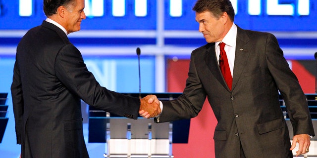 Sept. 12: Republican presidential candidates former Massachusetts Gov. Mitt Romney shakes hands with Texas Gov. Rick Perry before the start of a Republican debate in Tampa, Fla.