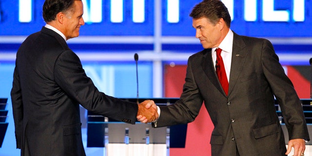 Sept. 12: Republican presidential candidates former Massachusetts Gov. Mitt Romney shakes hands with Texas Gov. Rick Perry before the start of a Republican debate in Tampa, Fla.