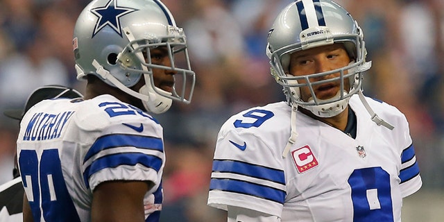 ARLINGTON, TX - OCTOBER 05: Tony Romo #9 of the Dallas Cowboys talks to DeMarco Murray #29 of the Dallas Cowboys against the Houston Texans in the first half at AT&T Stadium on October 5, 2014 in Arlington, Texas. (Photo by Tom Pennington/Getty Images)