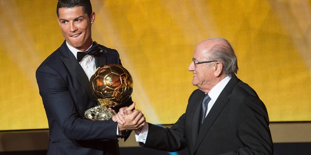Cristiano Ronaldo congratulated by FIFA President Joseph Blatter the 2014 prize at the FIFA Ballon d'Or.