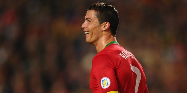 LISBON, PORTUGAL - NOVEMBER 15:  Cristiano Ronaldo of Portugal smiles after scoring during the National Anthems ahead of the FIFA 2014 World Cup Qualifier Play-off First Leg between Portugal and Sweden at Estadio da Luz on November 15, 2013 in Lisbon, Portugal.  (Photo by Mike Hewitt/Getty Images)