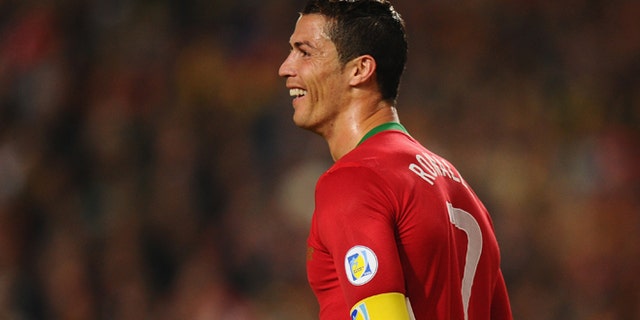 LISBON, PORTUGAL - NOVEMBER 15: Cristiano Ronaldo of Portugal smiles after scoring during the National Anthems ahead of the FIFA 2014 World Cup Qualifier Play-off First Leg between Portugal and Sweden at Estadio da Luz on November 15, 2013 in Lisbon, Portugal. (Photo by Mike Hewitt/Getty Images)