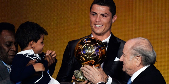 Cristiano Ronaldo of Portugal, center, is awarded the prize for the FIFA Men's soccer player of the year 2013 by FIFA President Sepp Blatter, right, and Pelé, left, at the FIFA Ballon d'Or 2013 gala at the Kongresshaus in Zurich, Switzerland, Monday, Jan. 13, 2014. (AP Photo, Keystone/Steffen Schmidt)
