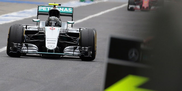 Mercedes driver Nico Rosberg of Germany returns to the pit lane on the way to winning the Japanese Formula One Grand Prix at the Suzuka International Circuit in Suzuka, central Japan, Sunday, Oct. 9, 2016. (Yuya Shino/Pool Photo via AP)