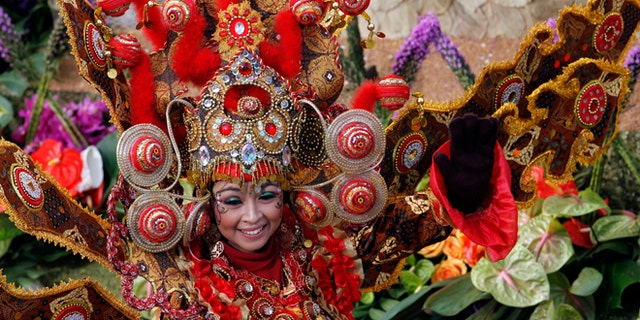 Jan. 1, 2013: A woman smiles from the float "Wonderful Indonesia" from the Ministry of Tourism and Creative Economies, Republic of Indonesia_the winner of the Presidents trophy for the most innovative use and presentation of flowers in the 124th Rose Parade in Pasadena, Calif.