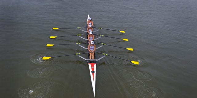 FILE - Members of the Vesper Rowing Club line up to compete in the 2012 National Rowing Championships at Cooper River in Cherry Hill, N.J. on July 14, 2012.